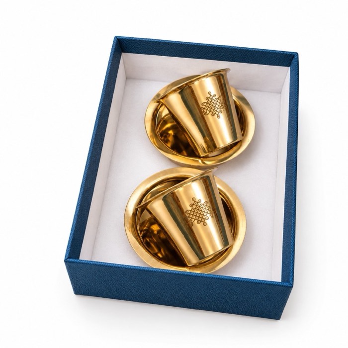 Two brass tumblers seated in a navy presentation box