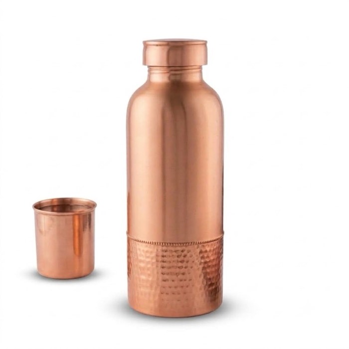 Hammered copper water bottle with a matching copper tumbler