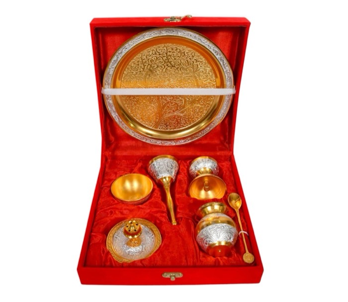 Puja set with gold thali and diyas in a red velvet box