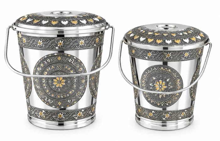 Pair of decorative metal buckets with engraved panels and handles