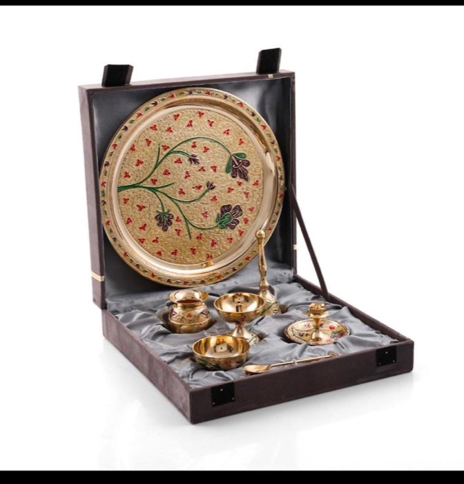 Puja thali set with small vessels in a dark presentation box