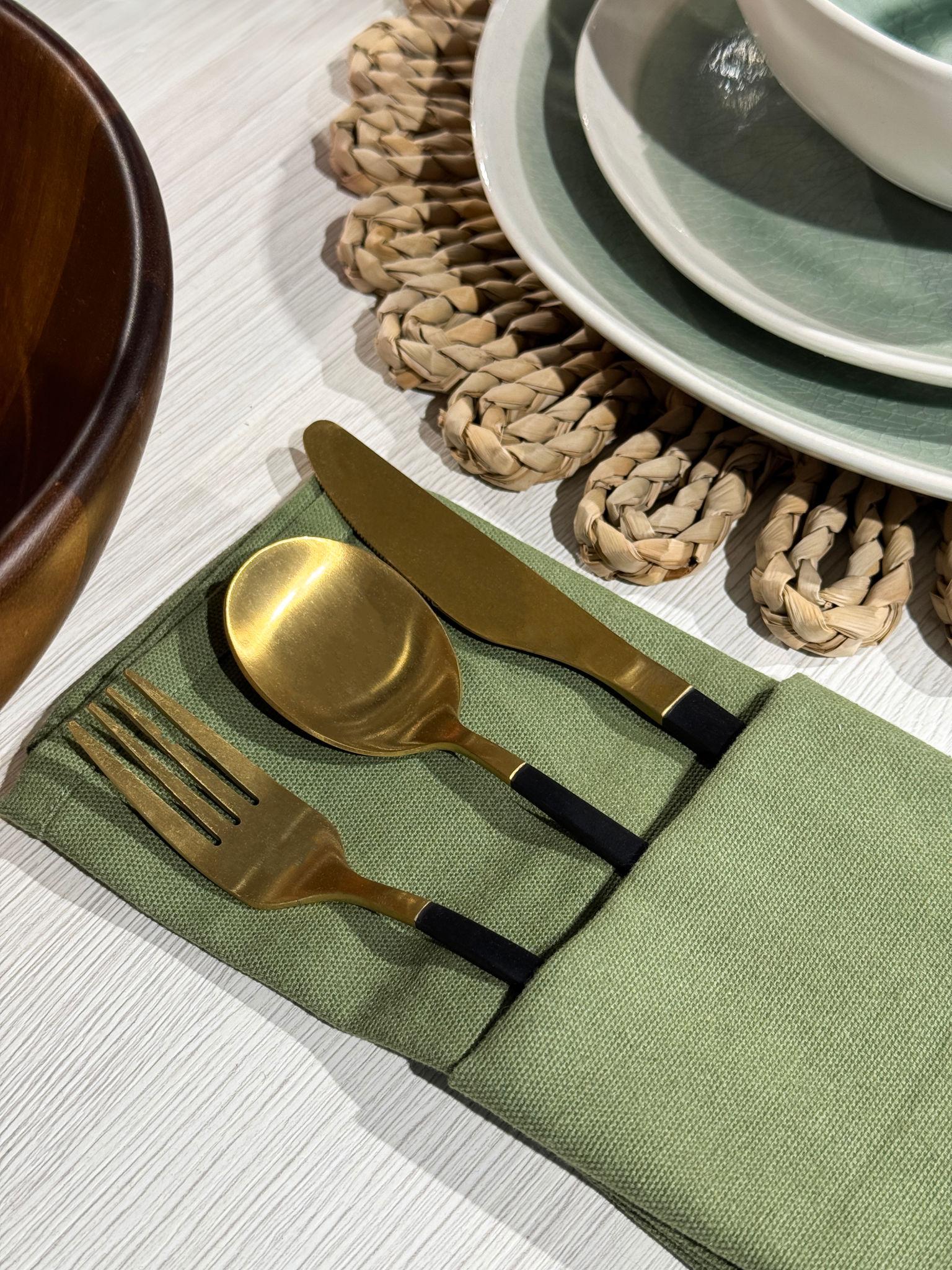 Gold-finished flatware resting on a linen napkin